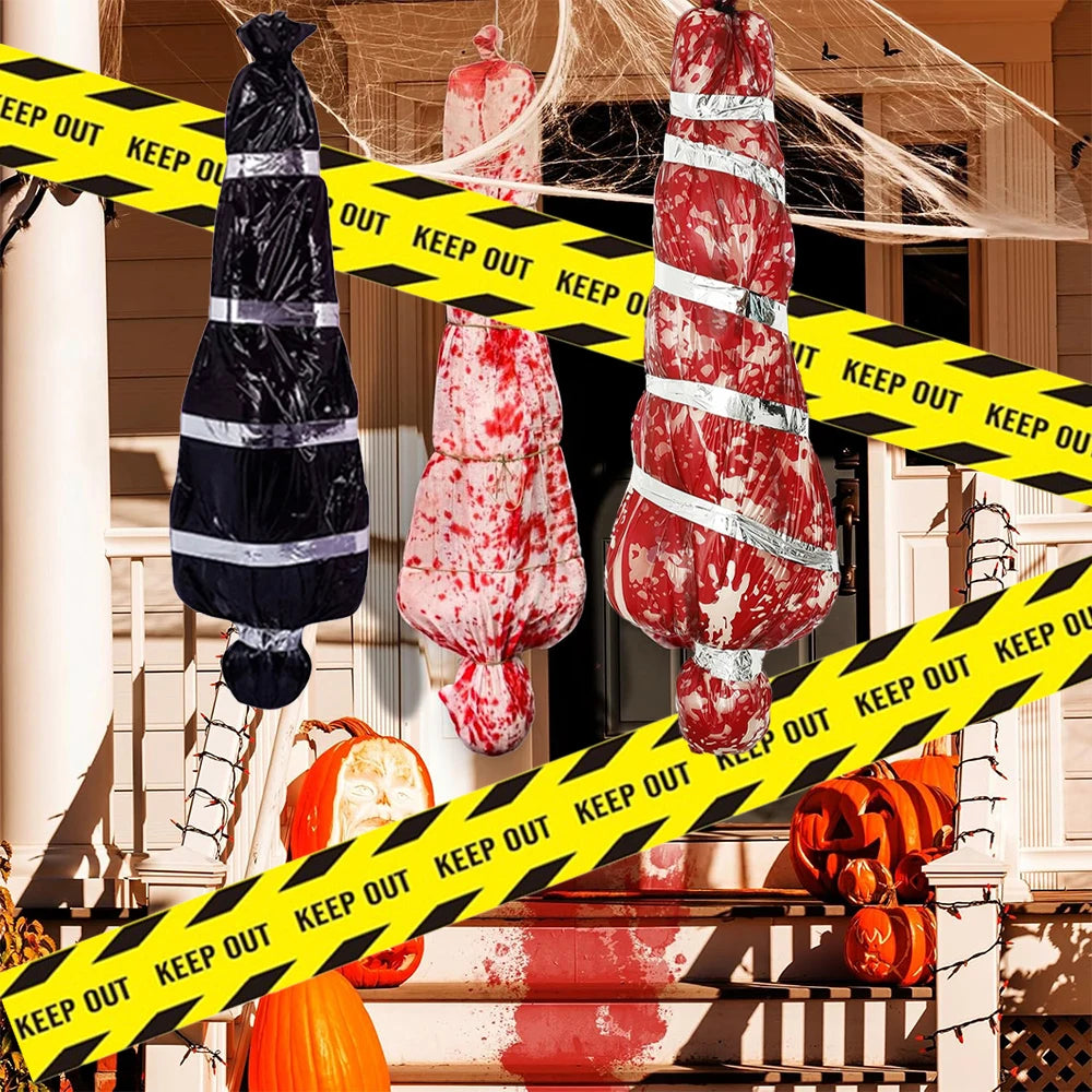 Halloween decorations with fake blood and 'Keep Out' tape on a house exterior.