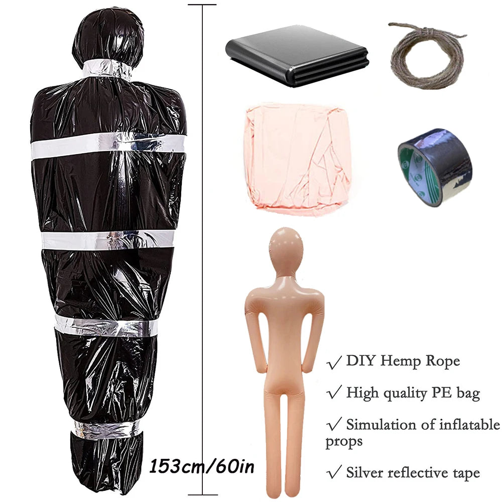 Collection of props including a black bag, pink inflatable model, and other items on a white background.