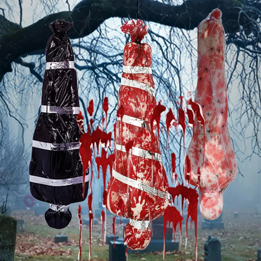 Horror-themed decorations including a black bag, red and white striped object, and a large pinkish-red object against a spooky background.
