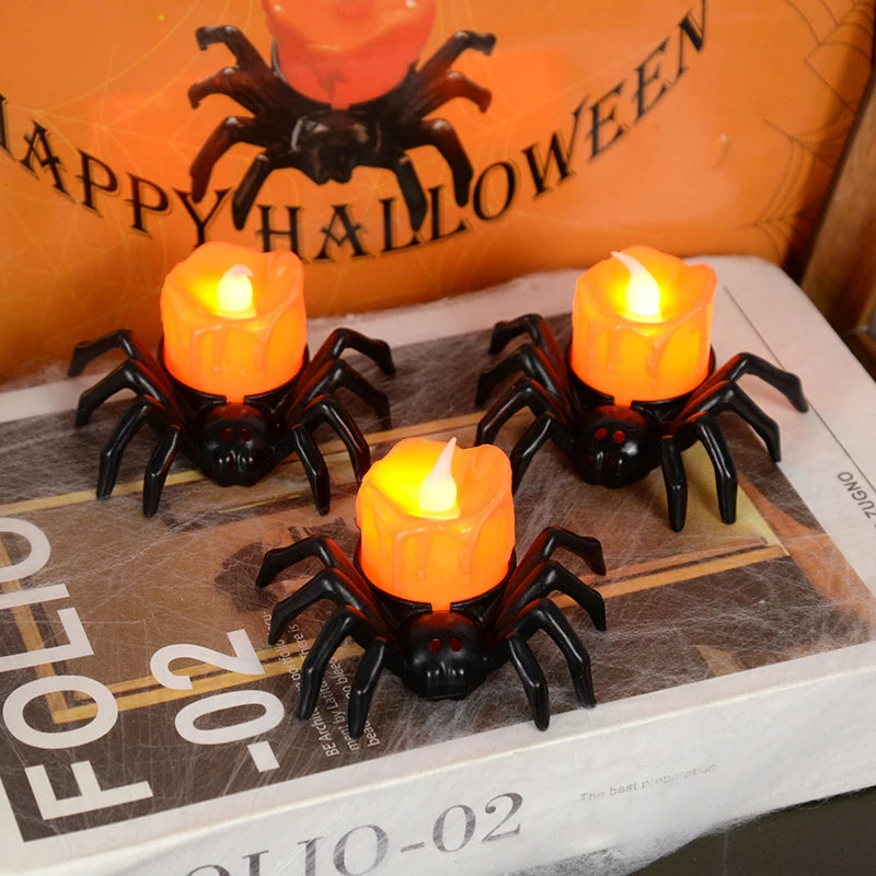 Spider-shaped candles with orange flames on a newspaper with 'Happy Halloween' text in the background.