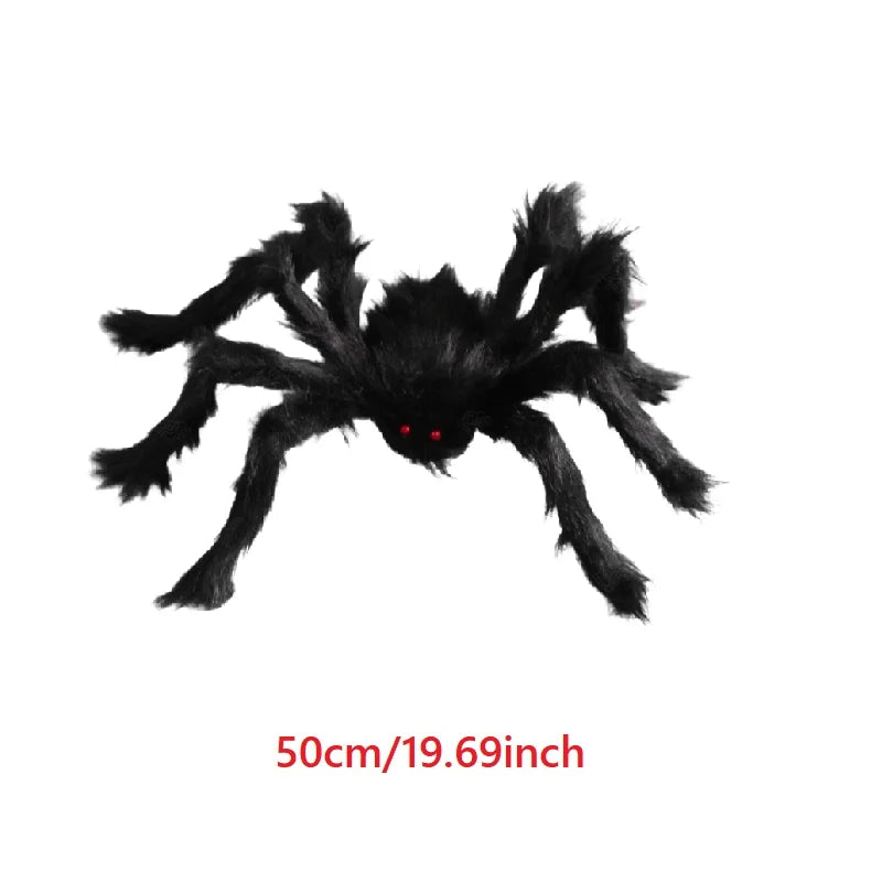 Black spider plush toy with red eyes on a white background
