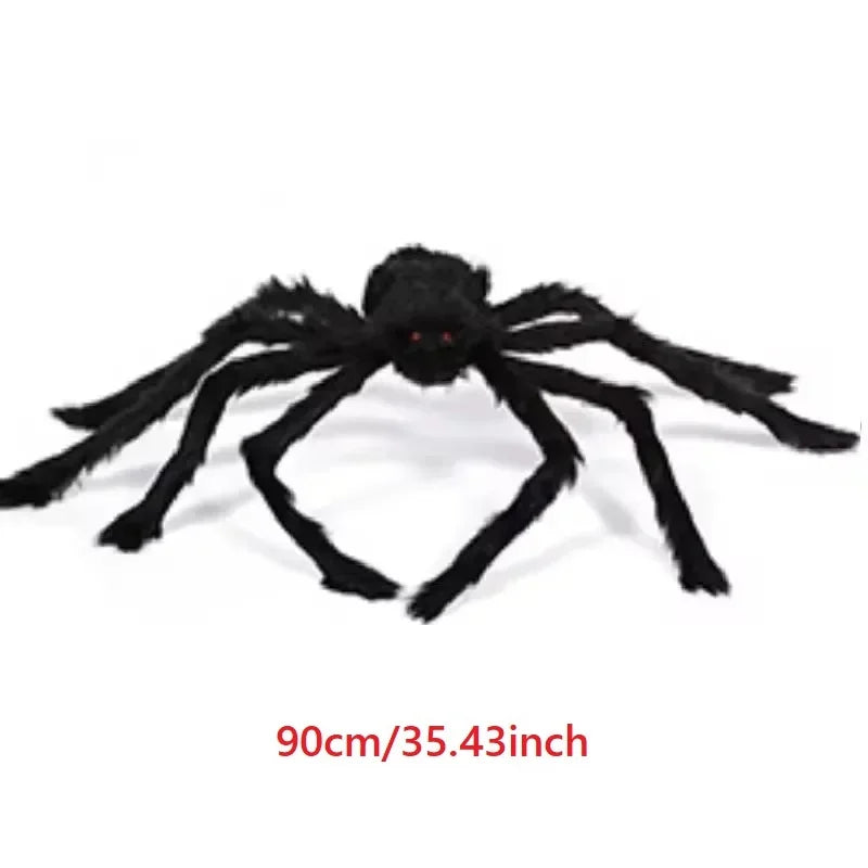 Large black spider toy with red eyes on a white background