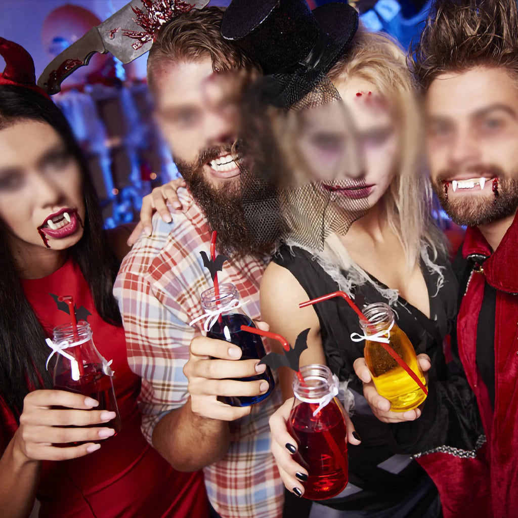 Group of people in Halloween costumes with drinks at a party.